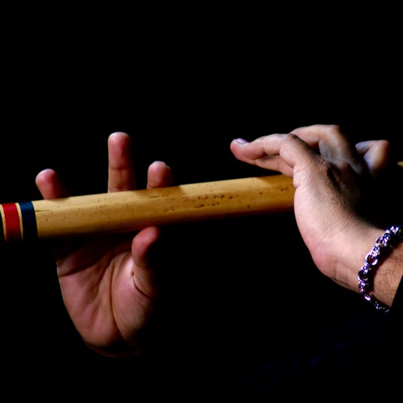 a person holding a wooden stick in their hand